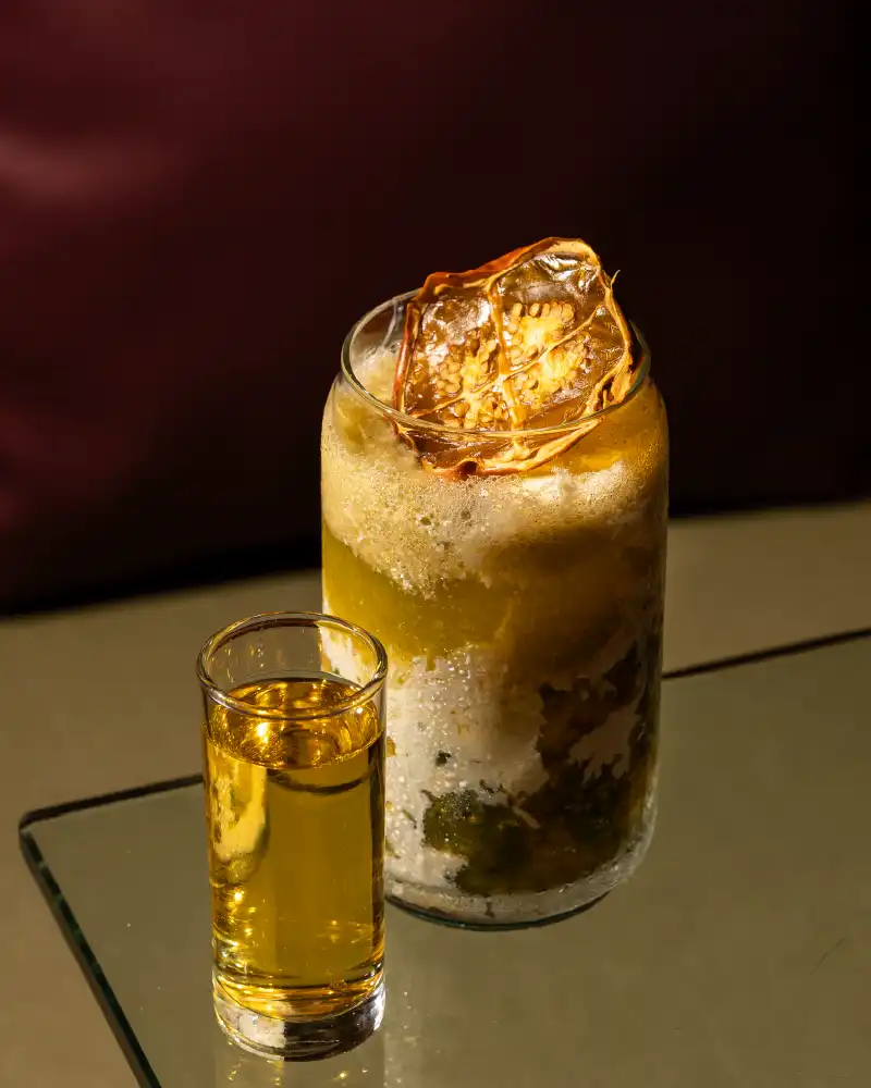 Signature tropical fruit cocktail with caramelized Colombian fruit garnish at Nía Bakery Coffee Shop and Cocktails, Cartagena